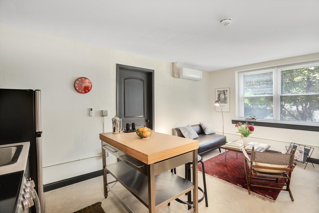 a living room with a dining room table and a couch