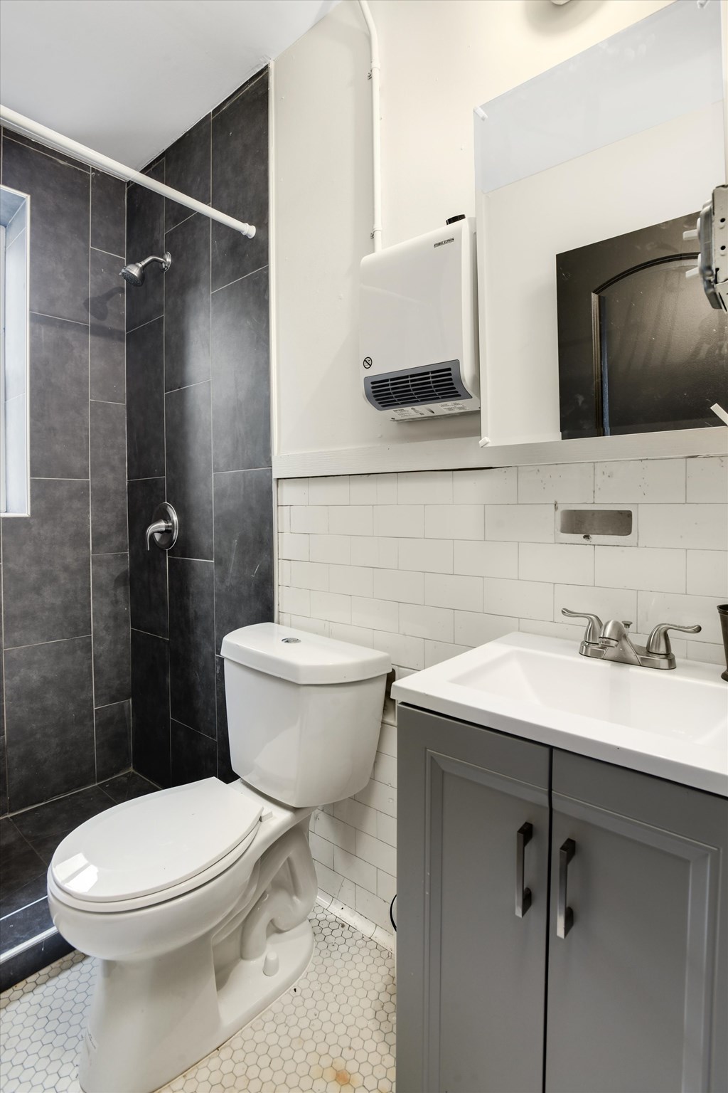 A white toilet sits next to a sink in a bathroom.
