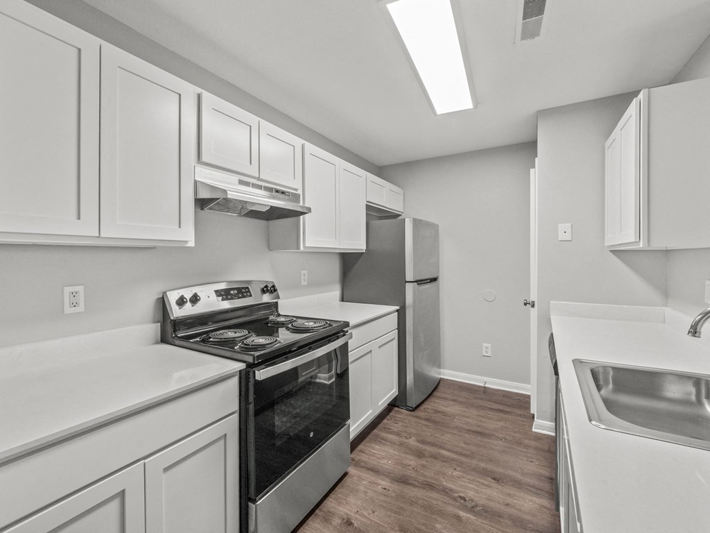 the preserve at ballantyne commons spacious kitchen with white cabinets and stainless steel appliances