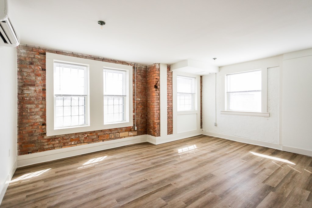 A room with wooden floors and white walls.