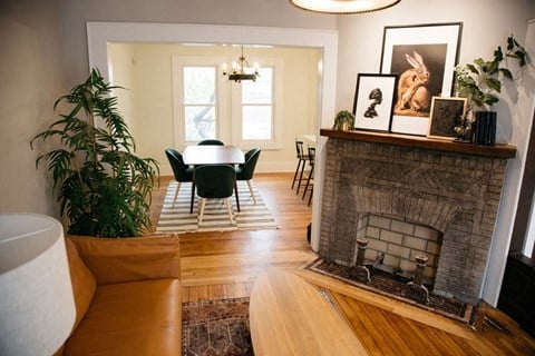 a living room with a fireplace and a table and chairs