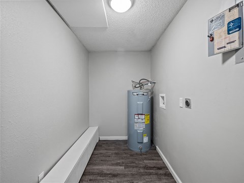 a room with a boiler and a water heater in it