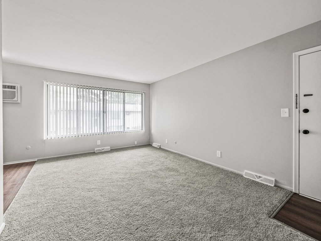 a bedroom with a large window and a door