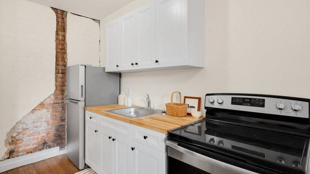 a kitchen with a stove and a sink and a refrigerator