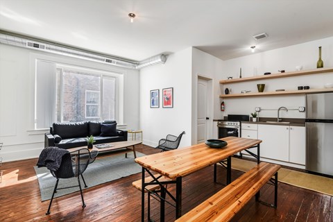 A kitchen with a table and chairs in the middle of the room.