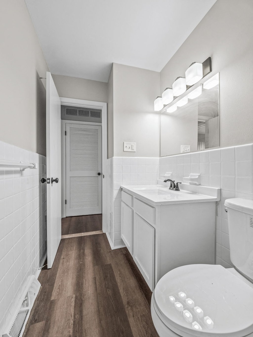 a bathroom with a toilet sink and mirror