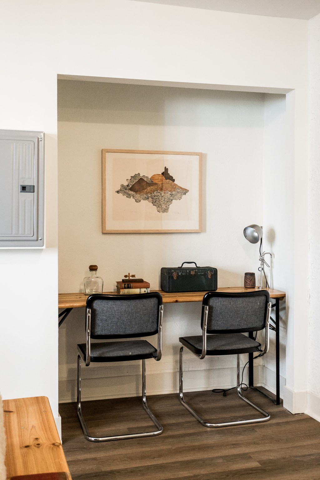 A room with a desk and two chairs.