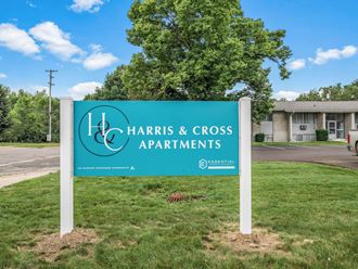 a sign in front of a building that says harris & cross apartments