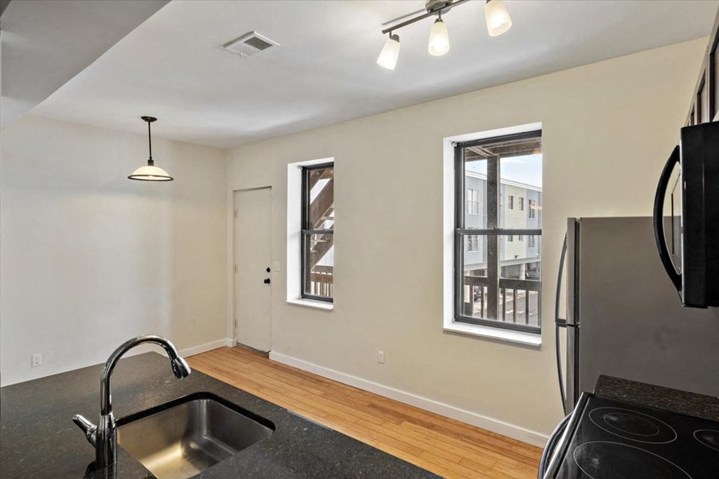 a kitchen with two windows and a sink