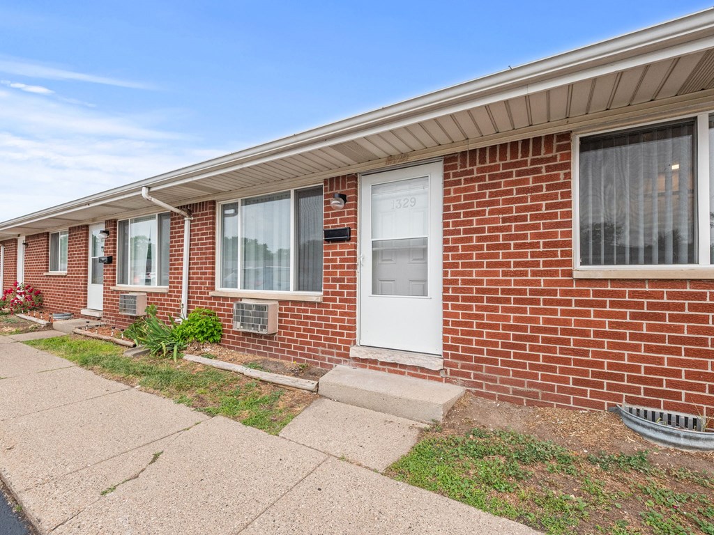 a brick building with a white door and windows