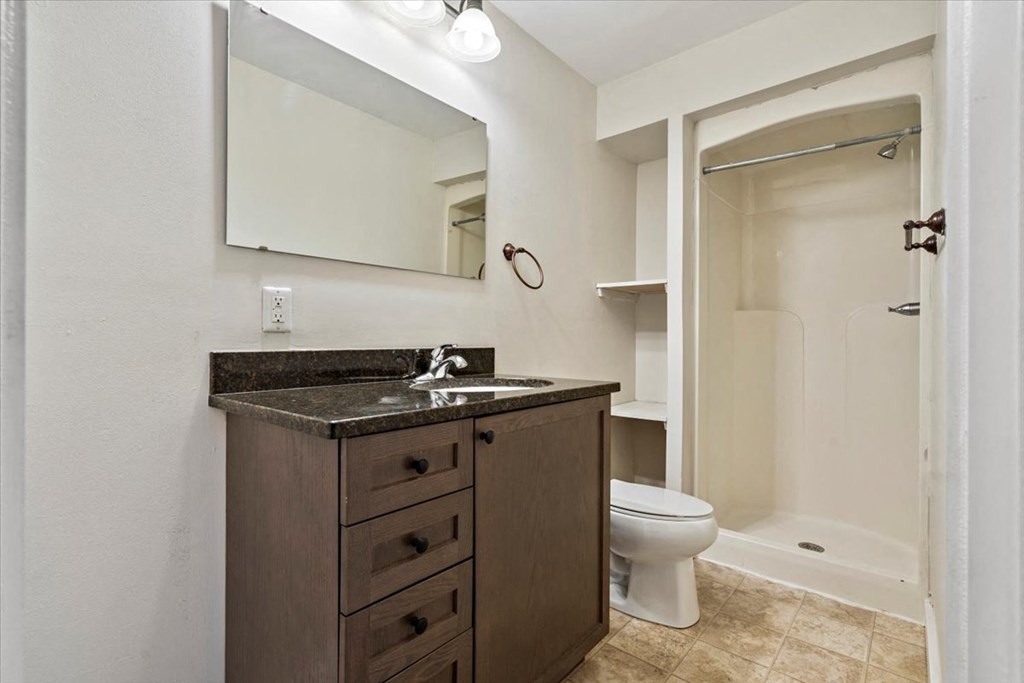 a bathroom with a sink toilet and shower