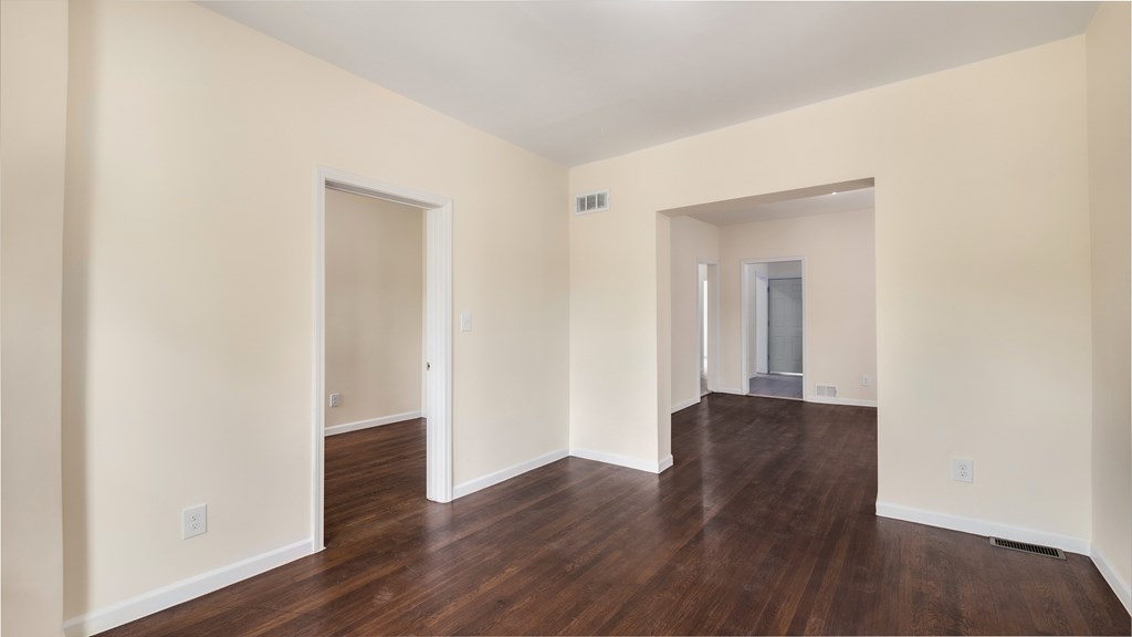 A room with wooden floors and white walls.