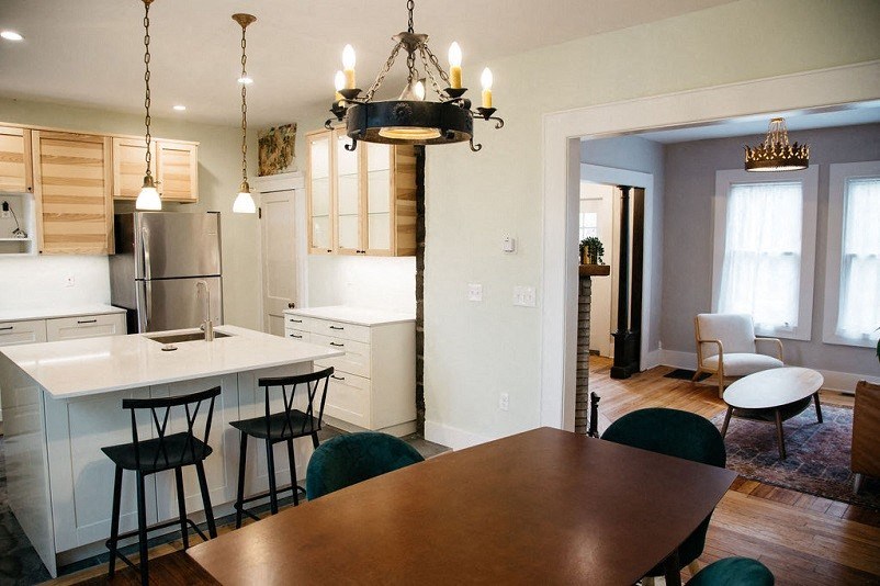 a kitchen and dining room with a table and chairs