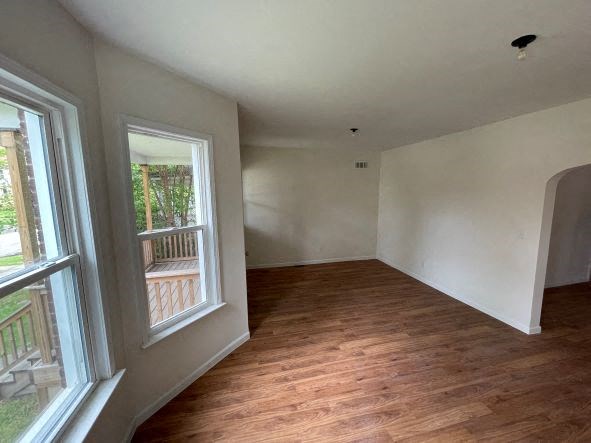 a empty room with a wood floor and a window