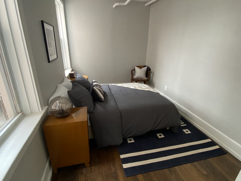 a bedroom with a bed and a window