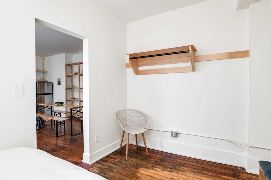 a bedroom with a bed and a chair