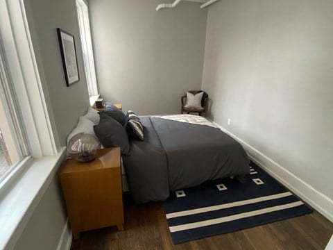 a bedroom with a bed and a window