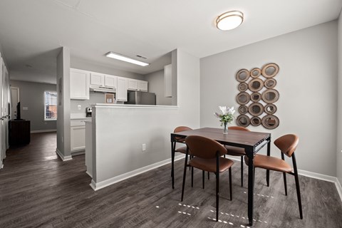 A dining room with a table set for two.