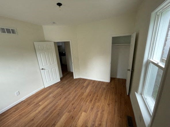 a empty room with a wooden floor and a door
