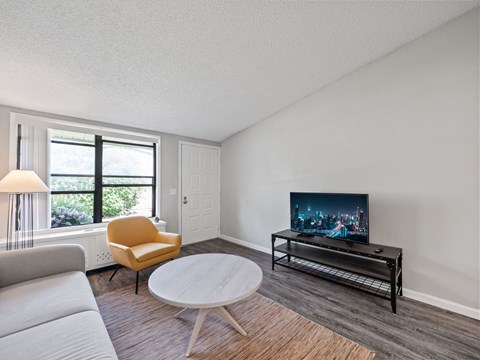 the living room of an empty apartment with wood flooring