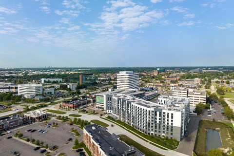 an aerial view of a city with tall buildings and a lake