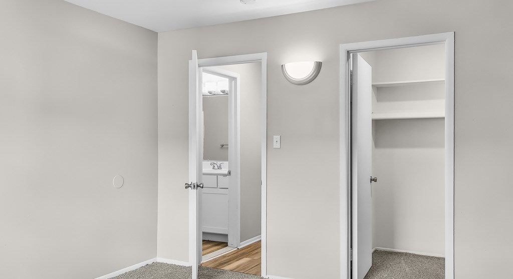 A white door is open to a hallway.