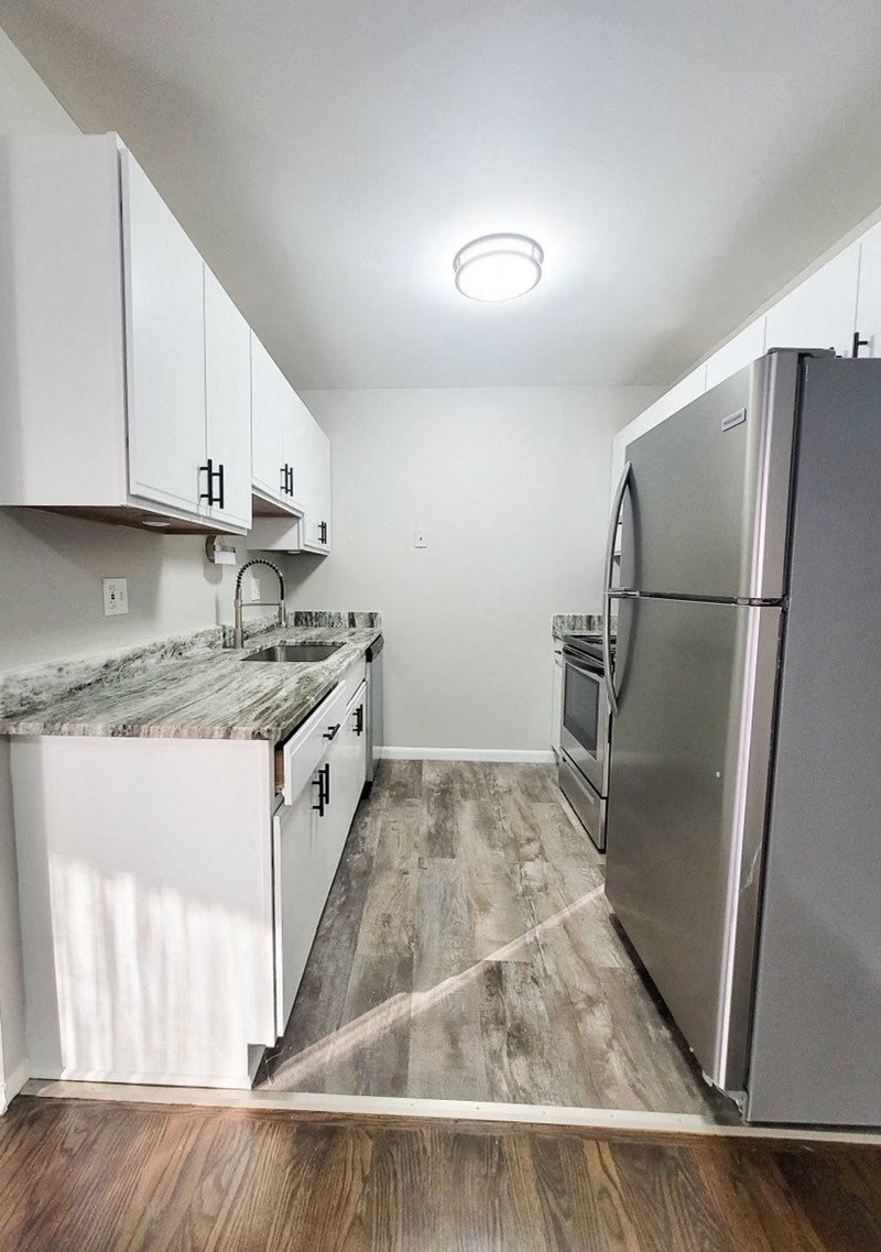 a kitchen with stainless steel appliances and white cabinets