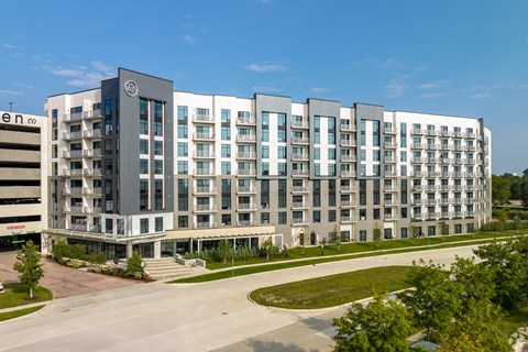 a large building with many windows and a street in front of it