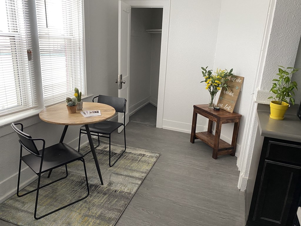 a small dining room with a table and chairs and a hallway