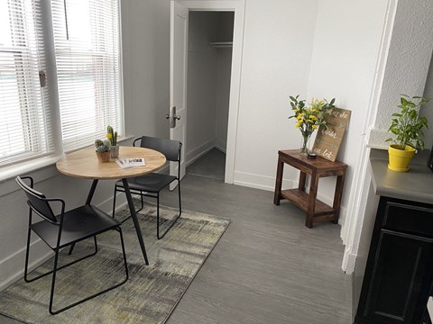 a small dining room with a table and chairs and a hallway