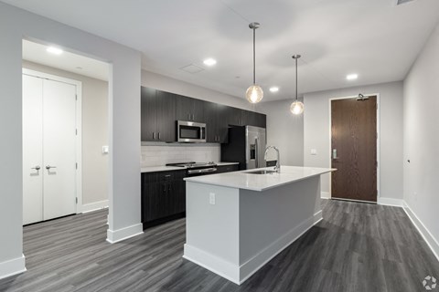 a renovated kitchen with a large island and black and white