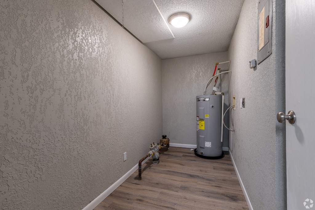 a room with a boiler and a water heater in it
