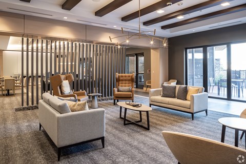 a living room with couches and chairs and a table