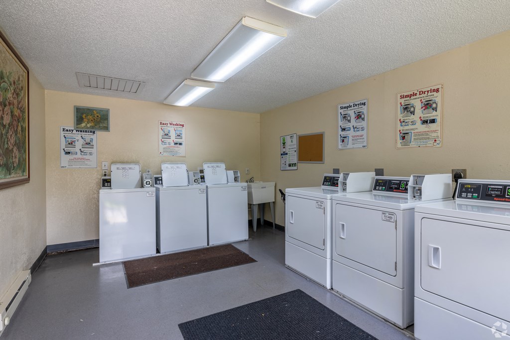 the laundry room is full of washes and dryers