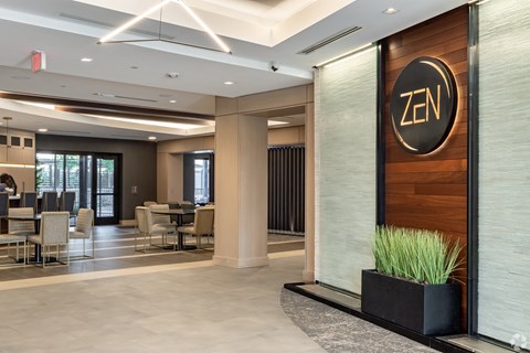 the lobby of an zn restaurant with tables and chairs