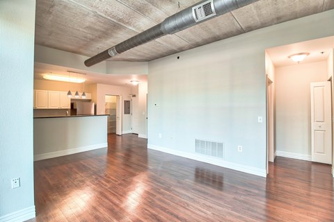 A room with a wooden floor and a white wall.