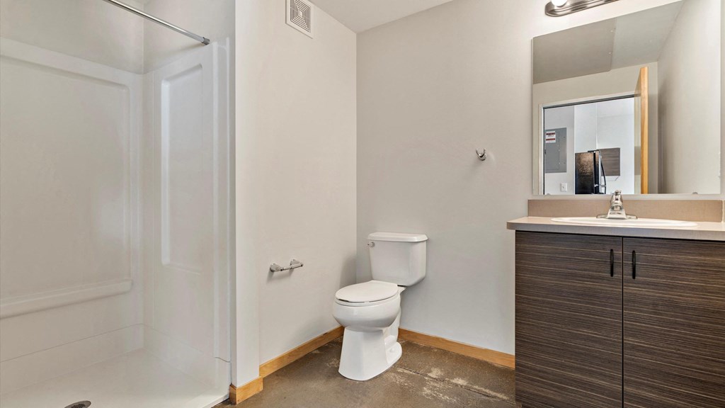 a bathroom with a toilet sink and shower
