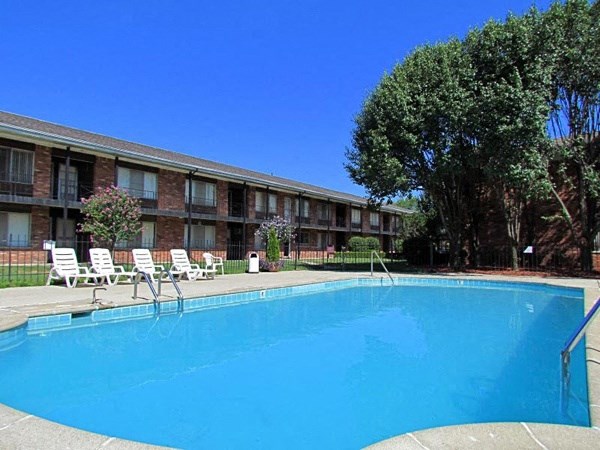 a large blue pool in front of a building