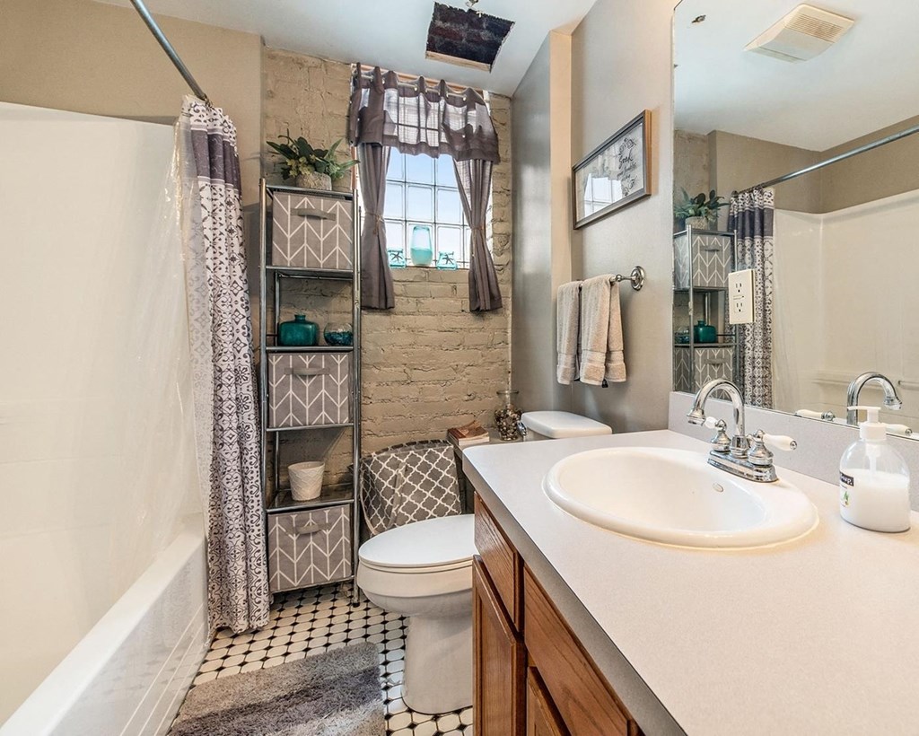 a bathroom with a toilet sink and shower