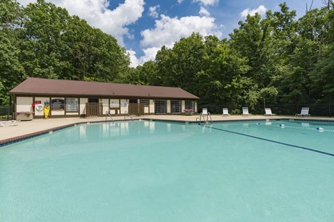 A large swimming pool with a building in the background.