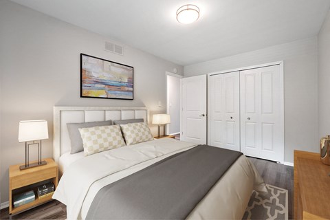 A bedroom with a large bed and a painting above it.