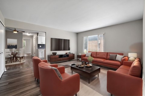A living room with a red couch and a coffee table.