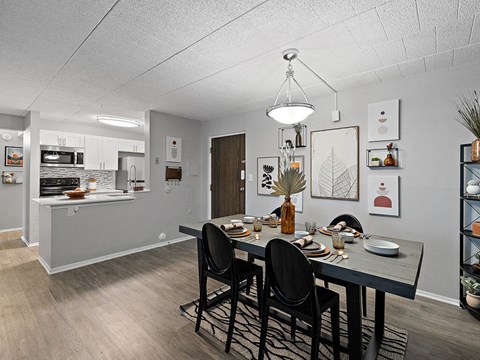 A dining room with a table set for four.