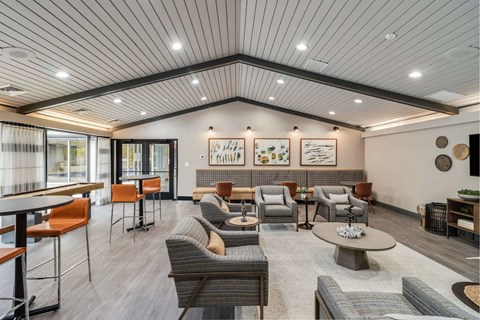 A spacious waiting area with a variety of seating options and artwork on the walls.