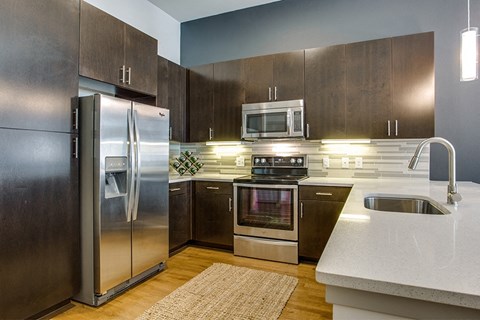 a kitchen with stainless steel appliances and wooden cabinets
