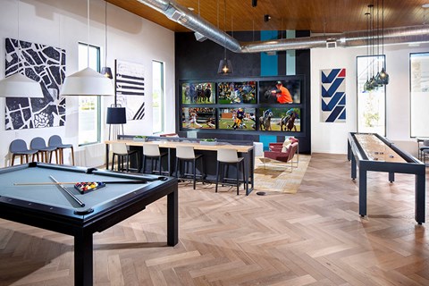 a living room with a pool table and a dining room