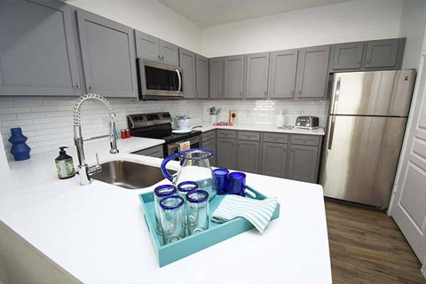 a kitchen with stainless steel appliances and a white counter top