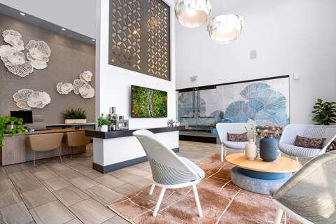 A modern living room with a dining area and a large painting on the wall.
