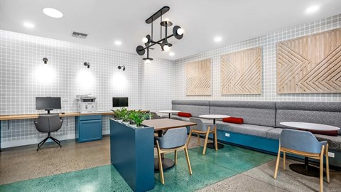 A modern office space with a blue accent wall and wooden furniture.