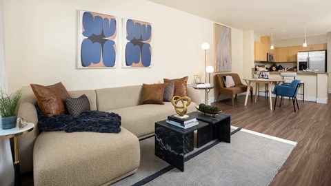 A living room with a grey sofa and a coffee table in front of it.